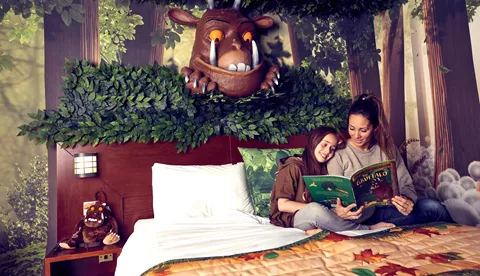 Gruffalo Hotel Room - parent reading to child on bed